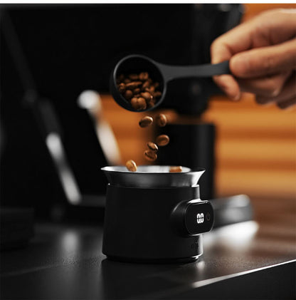 MHW-3BOMBER ES8031 black ESP coffee scale — pouring beans into the matching weighing cup