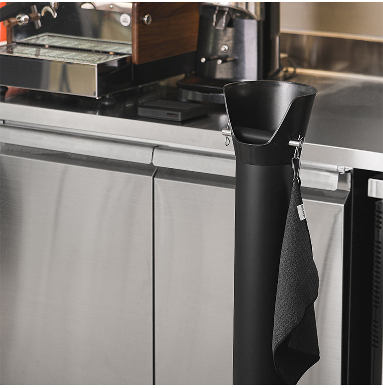 MHW-3BOMBER GB5449 black standing knock bin — full-height placement beside an espresso counter