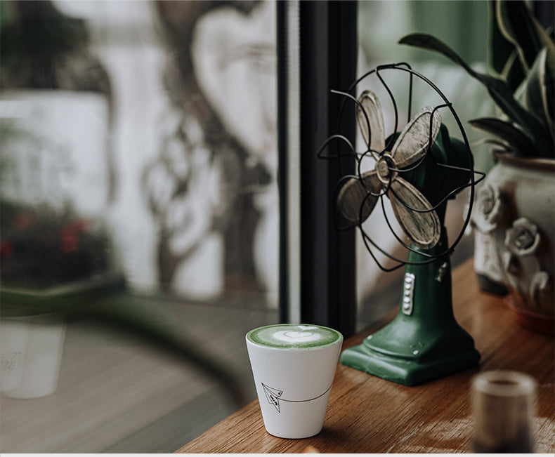 MHW-3BOMBER Winter Cup C5090W Morning Mist White beside a vintage fan