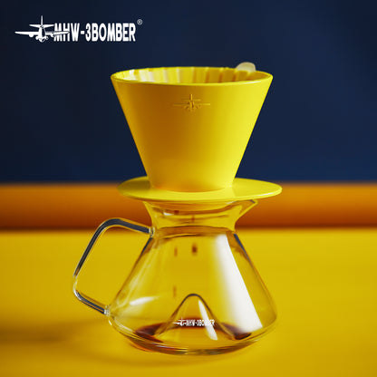 MHW-3BOMBER FC6606Y — yellow Oval dripper side profile resting on a server; other tools are scene props