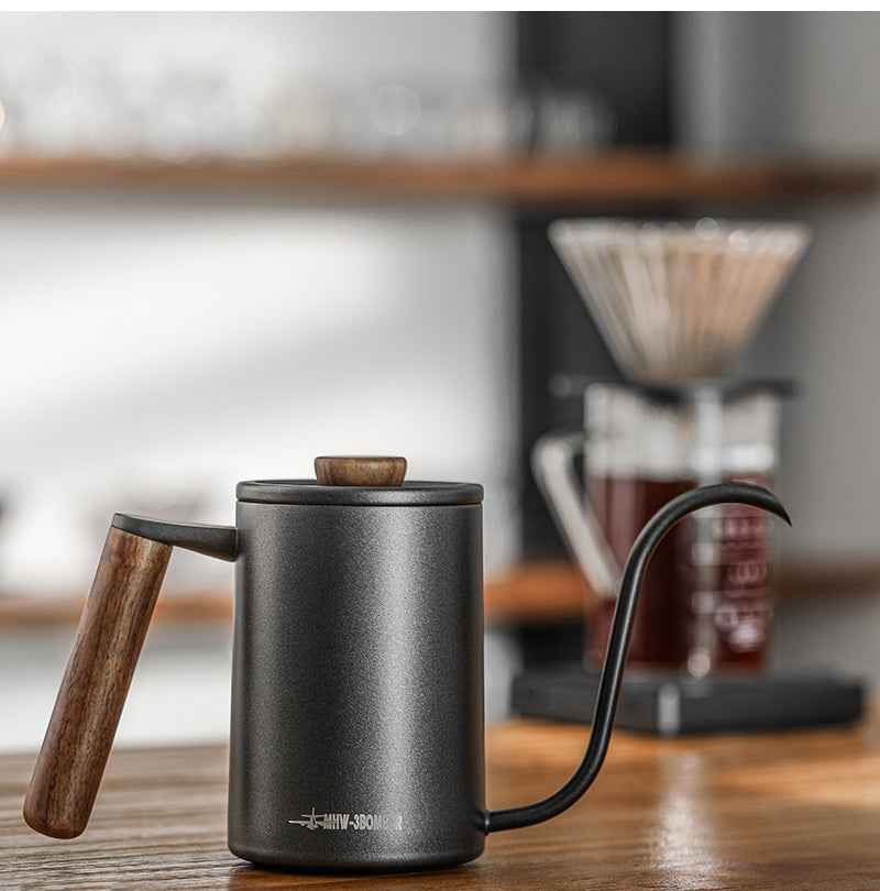 MHW-3BOMBER black cylindrical Planet kettle on a wooden brew counter