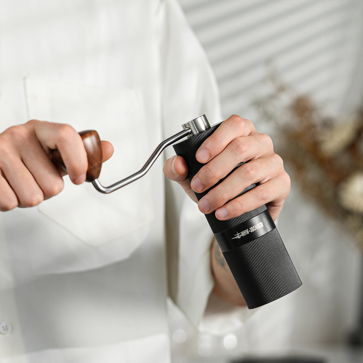 MHW-3BOMBER Racing M1 black manual grinder being cranked by hand