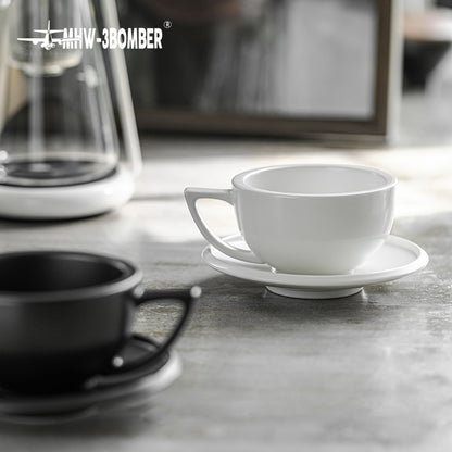 MHW-3BOMBER Sawada — 280 ml Mineral White empty cup and saucer on a stone counter; drinks, decoration and other tools are scene props