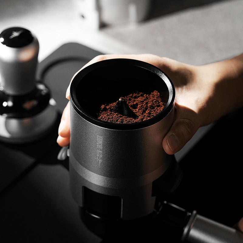 MHW-3BOMBER SE Pro black shaker held with coffee grounds inside