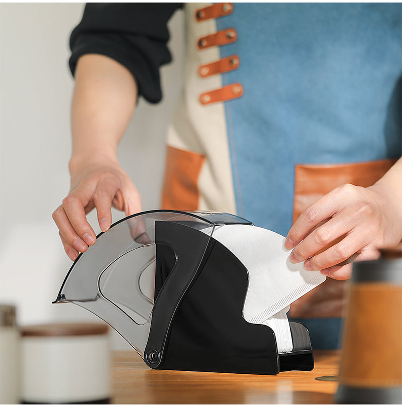 MHW-3BOMBER paper filter being taken from a black Snail holder; filters not included