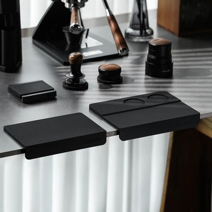 MHW-3BOMBER SP5309B black B-style tamping mat on the right; A-style mat and coffee tools shown for comparison and not included