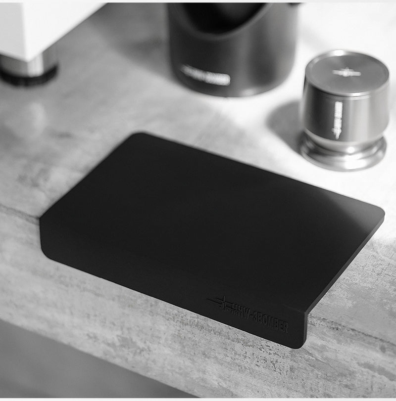 MHW-3BOMBER black A-style mat fitted over a counter edge with a separate tamper