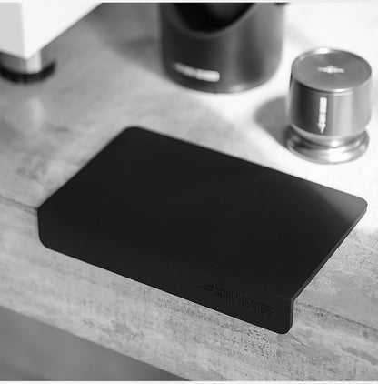 MHW-3BOMBER black A-style mat fitted over a counter edge with a separate tamper