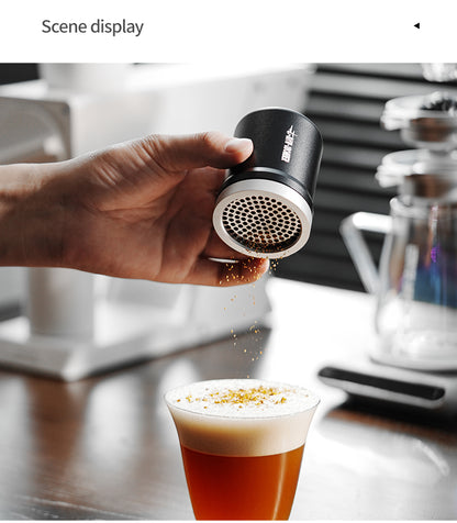 MHW-3BOMBER SP5693B black powder shaker held beside an espresso machine