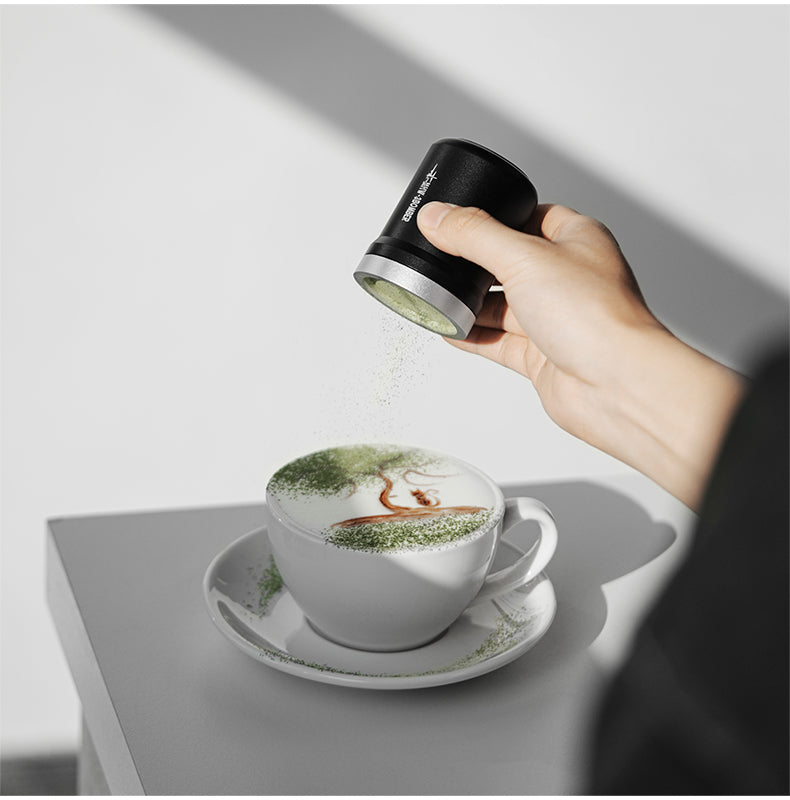 MHW-3BOMBER SP5693B black powder shaker held above a white cup with green powder