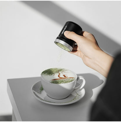 MHW-3BOMBER SP5693B black powder shaker held above a white cup with green powder