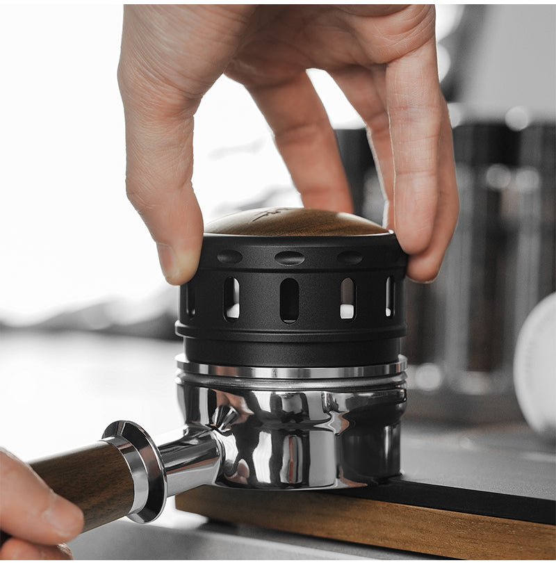 MHW-3BOMBER Falcon distributor seated over a portafilter; portafilter not included