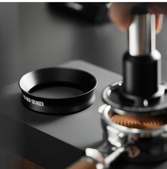 MHW-3BOMBER black magnetic dosing ring standing beside espresso tools