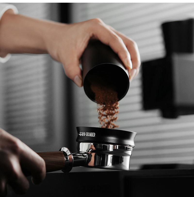 MHW-3BOMBER coffee grounds poured through a dosing ring into a portafilter