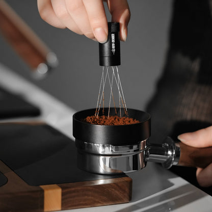 MHW-3BOMBER T6126 black Lightning WDT Tool 2.0 held upright above coffee grounds; dosing ring and portafilter not included